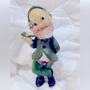 Vintage green Leprechaun figure, smiling, hard plastic, some wear